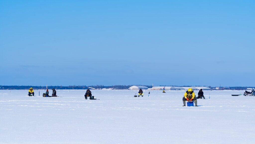 Ice Fishing. Winter fishing on ice at sea, Estonia.